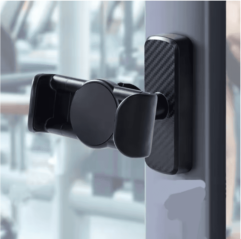 Black magnetic phone mount with carbon fiber texture attached to a vertical metal pole.